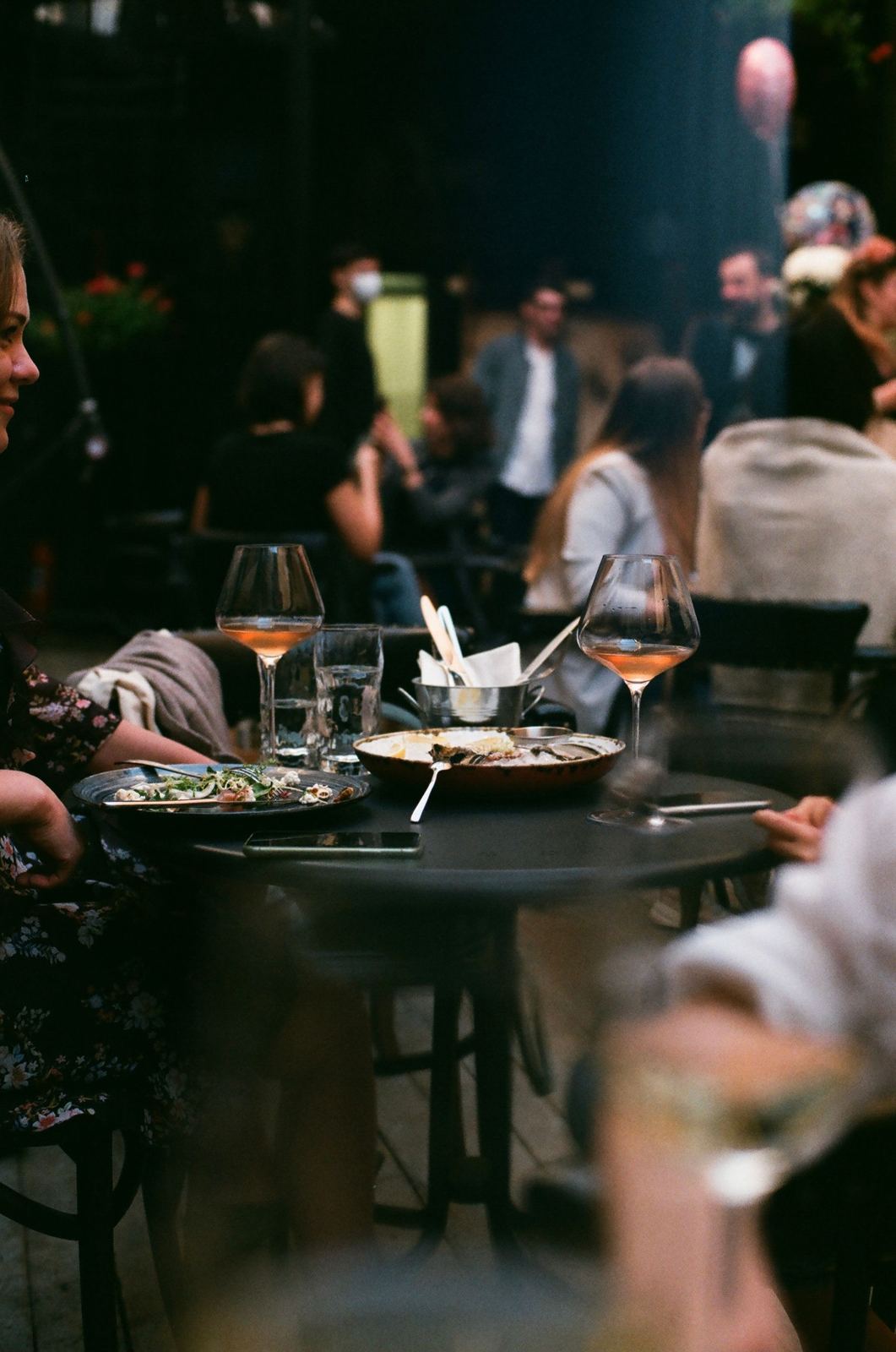Guests sharing dishes at a busy restaurant table
