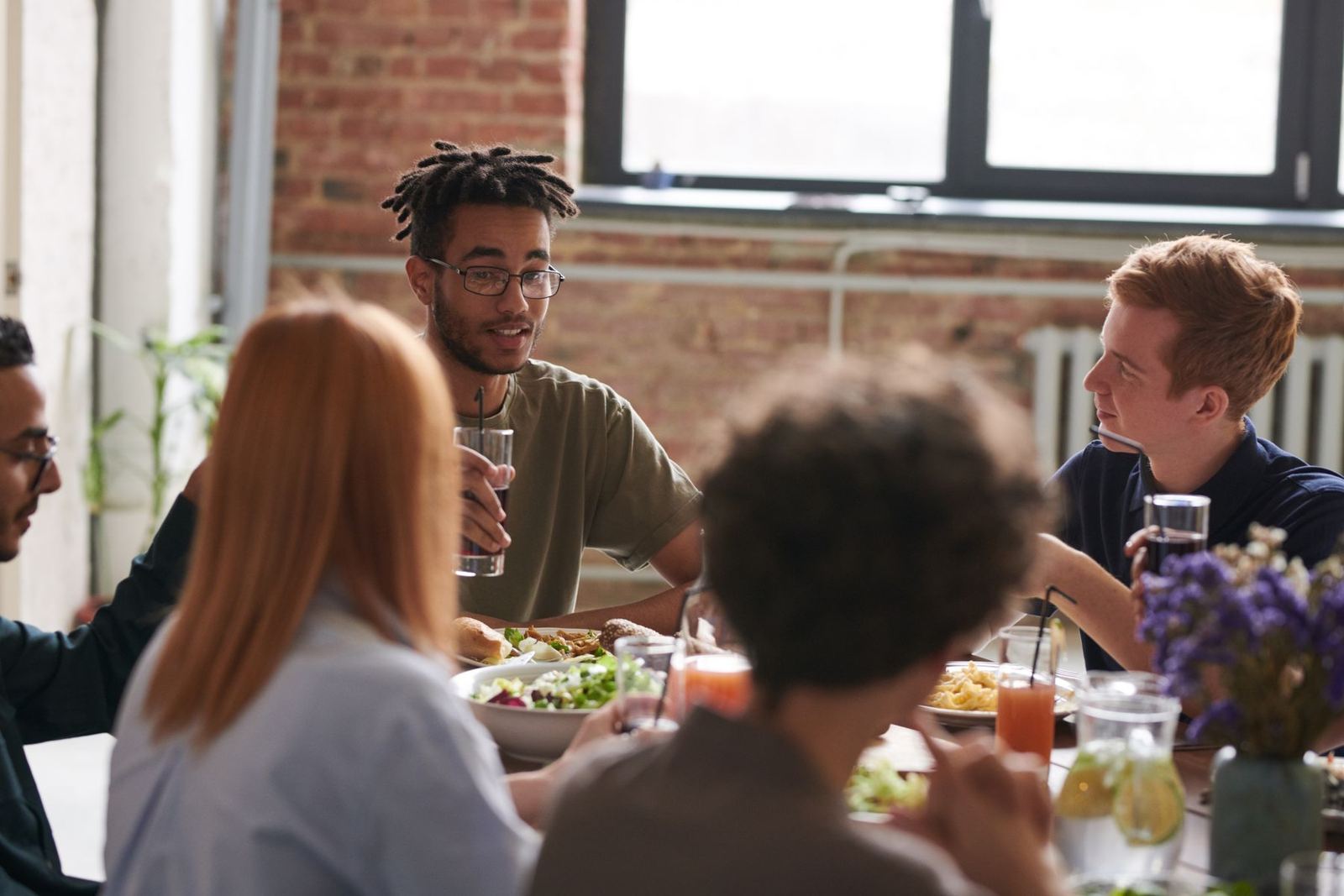Friends enjoying a meal together at a restaurant table