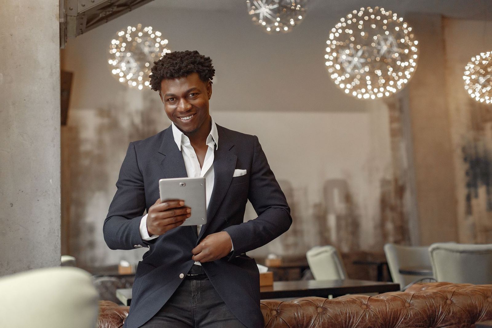A restaurant manager checking orders on a tablet