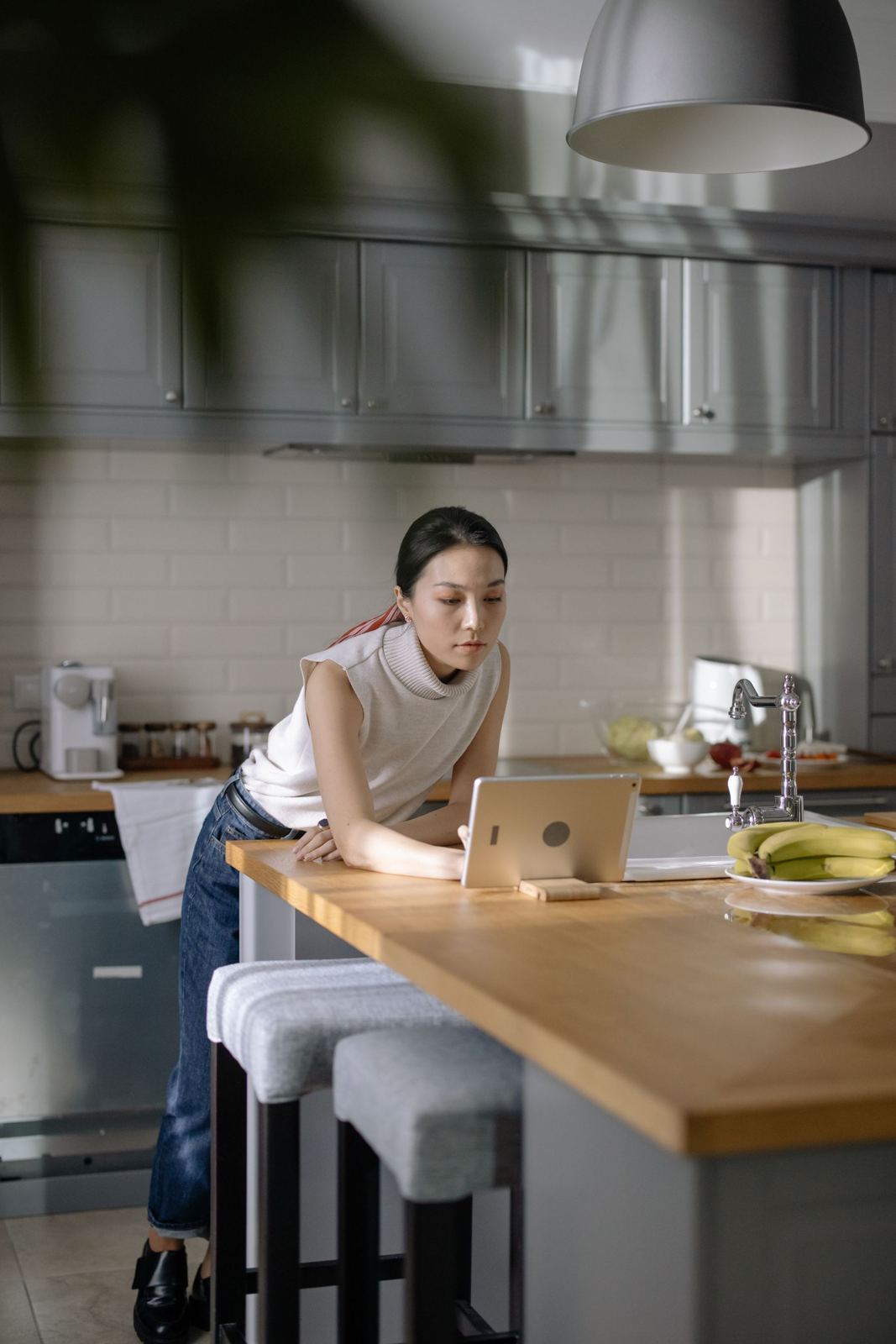 A staff member checking new orders on a tablet in the kitchen
